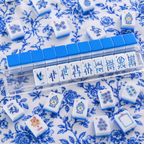 Set of blue and white tiles with Chinese characters on a floral patterned surface