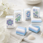 Close-up of acrylic Mahjong tiles with blue layered edges and lotus artwork