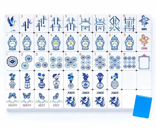 Close-up of American Mahjong tiles with porcelain vase and bamboo artwork