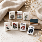 Deep green acrylic Mahjong tiles with caramel layered edges and botanical artwork