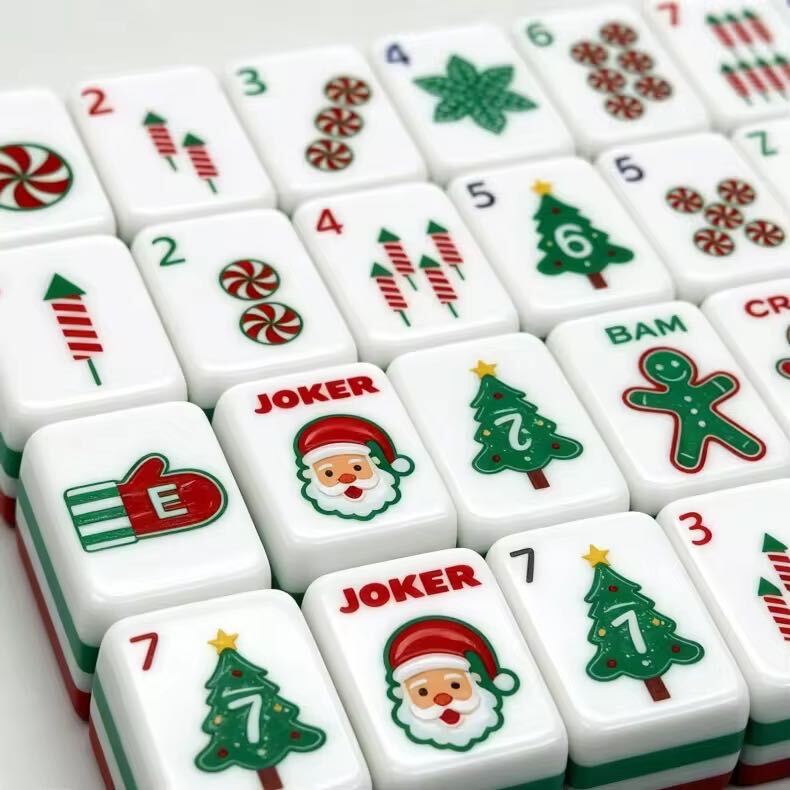 A Christmas-themed mahjong tile set for holiday game nights, festive gifting, and seasonal display. The red, green, and white layered tiles include Christmas trees, candy canes, Santa-style jokers, and other holiday details.