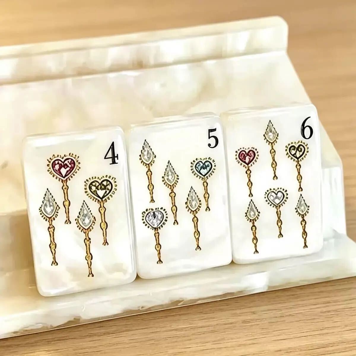 Close-up of Jewel Pearl Mahjong tiles with gemstone-inspired floral artwork